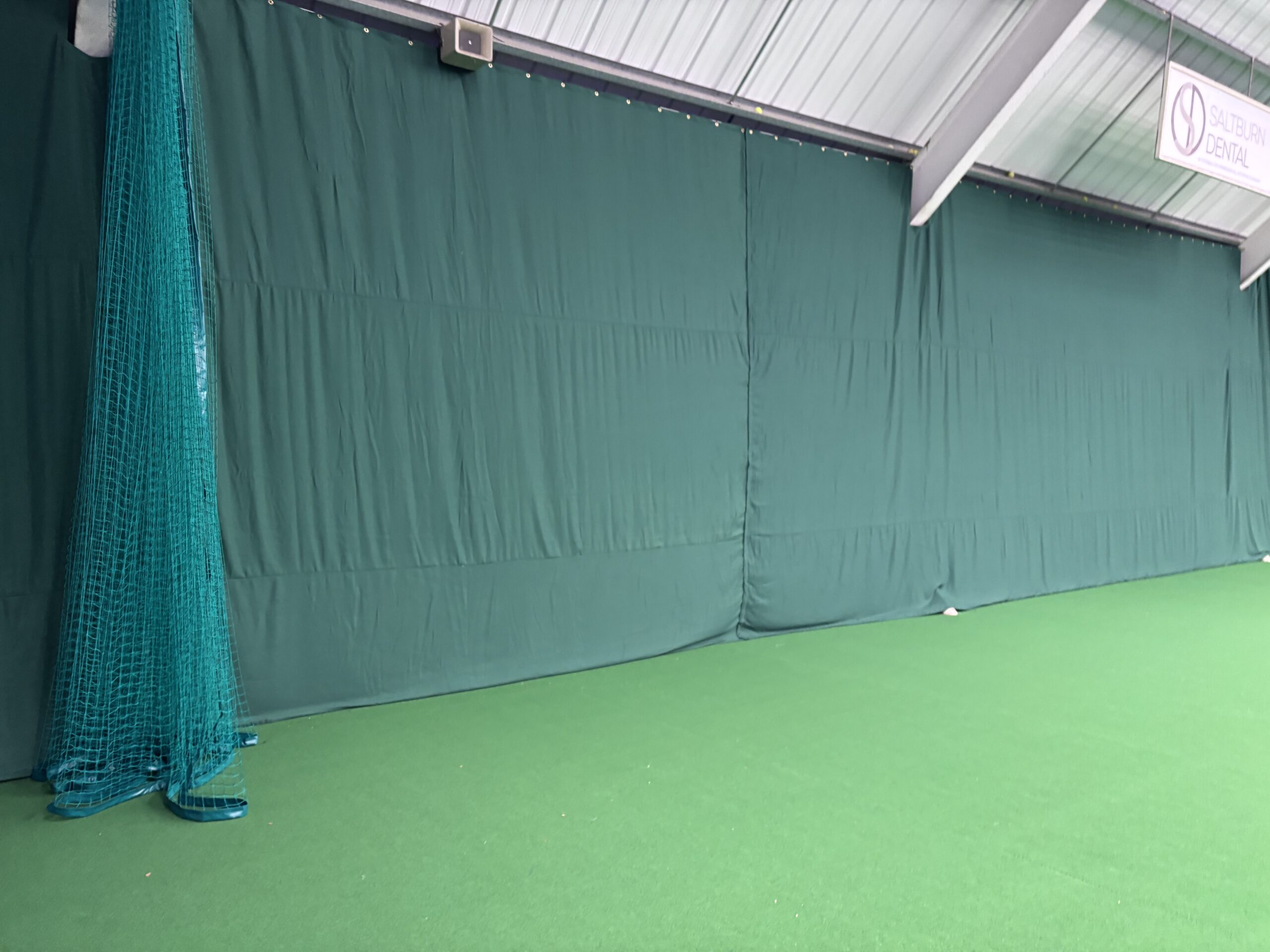 Completed indoor backdrop and divider netting installation